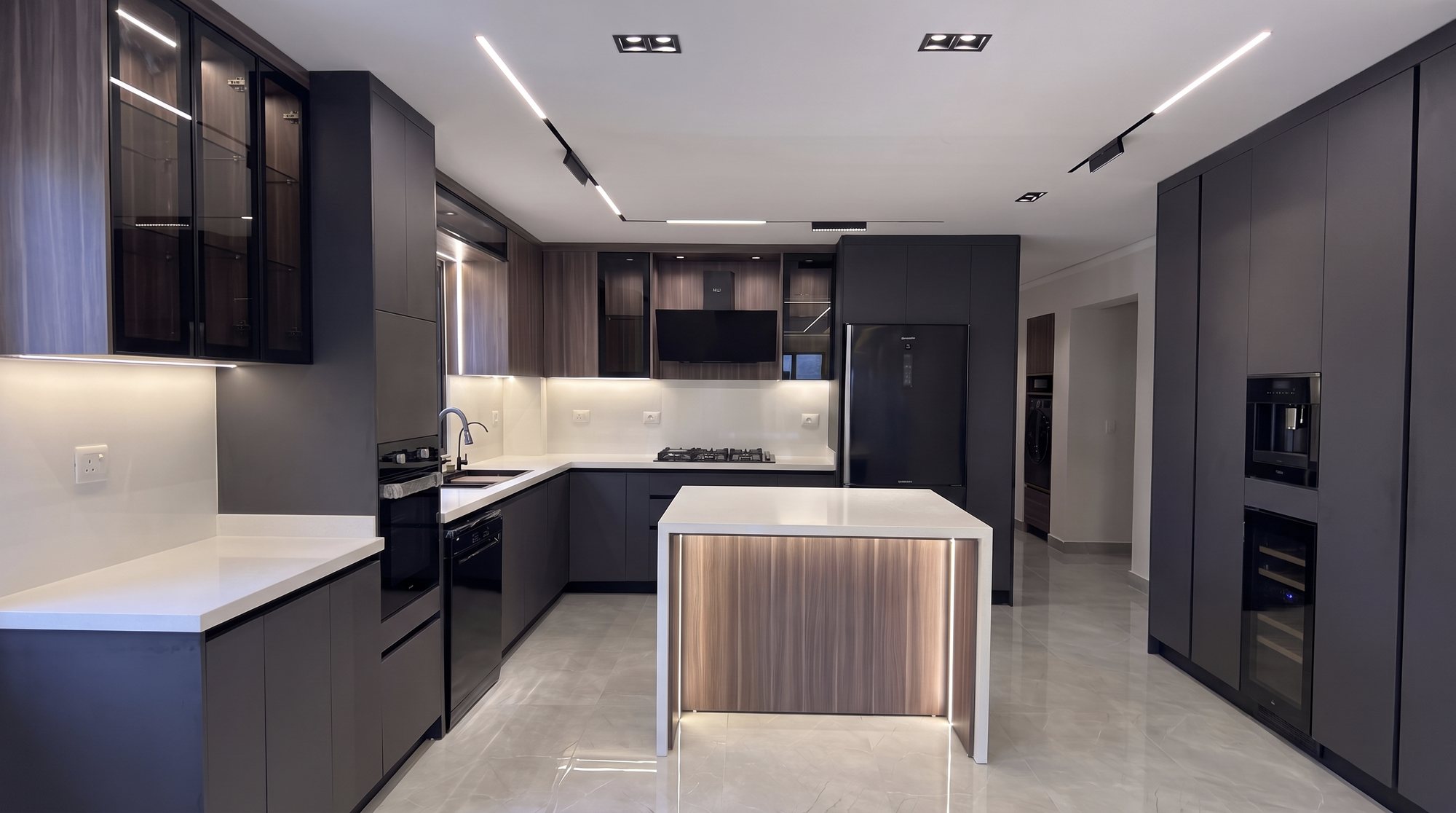 DHOME dark kitchen with a lit walnut island